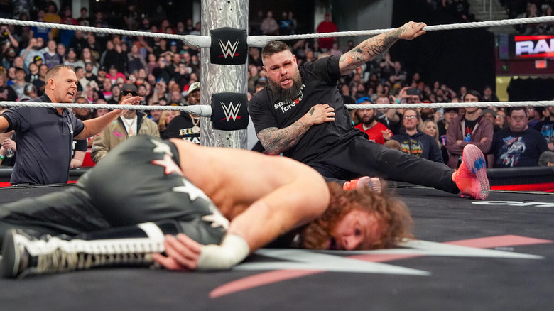 Kevin Owens stares at a fallen Sami Zayn in the ring on "WWE Raw"