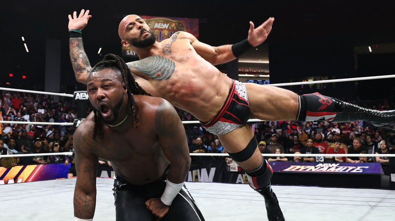 Ricochet hits Swerve Strickland with a move in the middle of the ring, with Strickland on his knees following a low blow, on an episode of "AEW Dynamite."