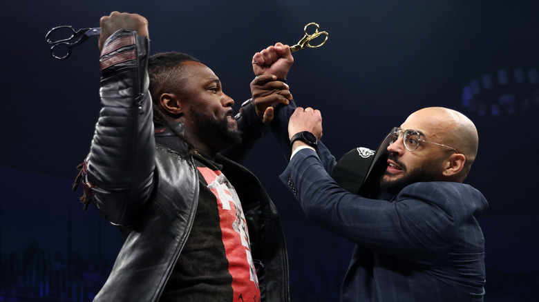 Swerve Strickland and Ricochet go after each other with scissors in their hands in the ring after a contract signing on an episode of "AEW Dynamite."