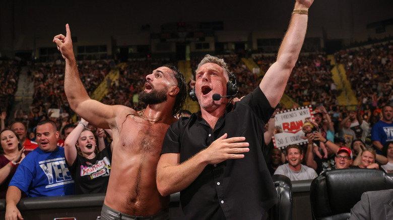 Seth Rollins and Pat McAfee sing with audience during Monday Night RAW at WSU Nutter Center on July 15, 2024 in Dayton, Ohio.