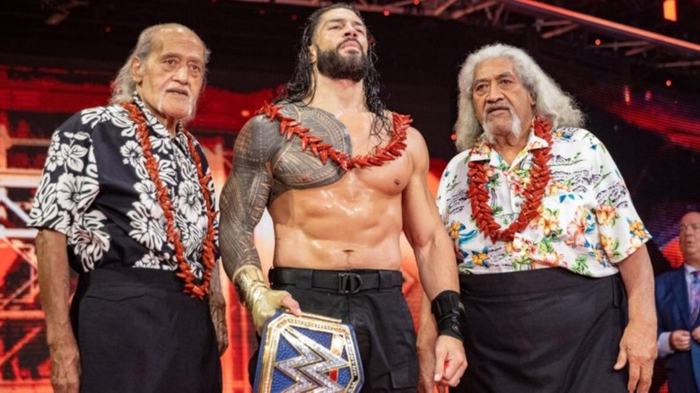 Roman Reigns celebrates with his father and uncle, the Wild Samoans