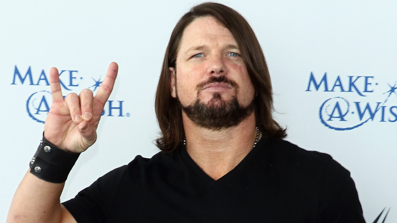 AJ Styles Giving The Bullet Club Hand Gesture