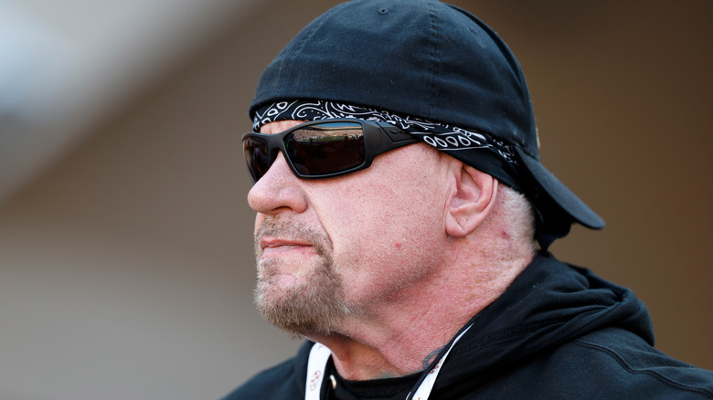 Mark "The Undertaker" Calaway wearing a backwards cap and sunglasses