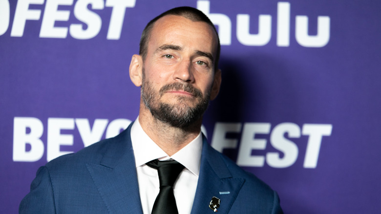 CM Punk wearing a suit and tie