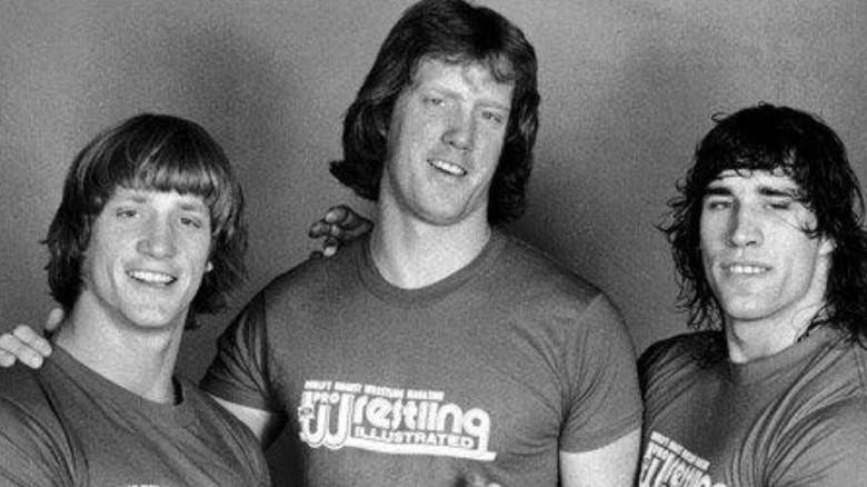 Three of the Von Erich brothers are seen posing backstage for a photo for Pro Wrestling Illustrated.