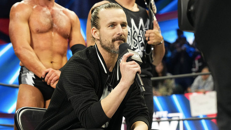 Adam Cole sitting with a microphone