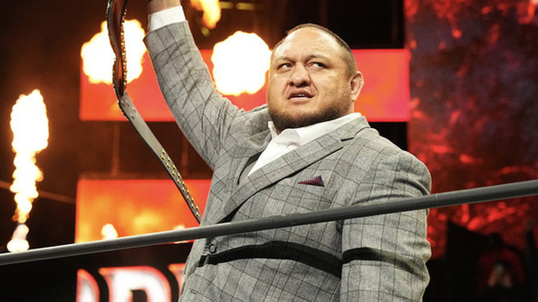 Samoa Joe raising his championship