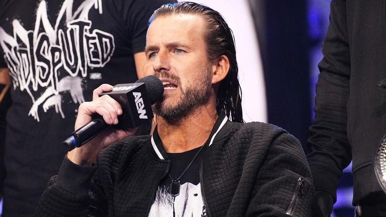 Adam Cole speaking into microphone