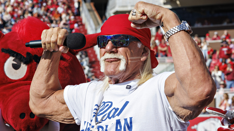 Hulk Hogan flexing both arms at a sporting event