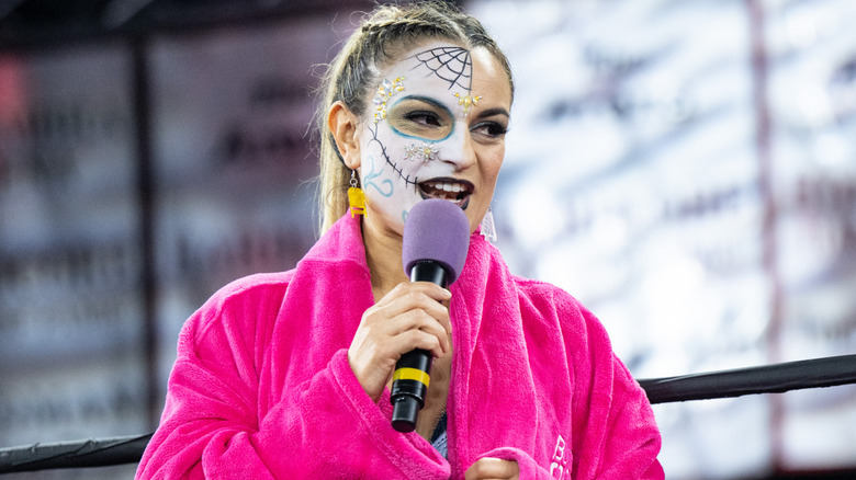 Thunder Rosa holding a microphone