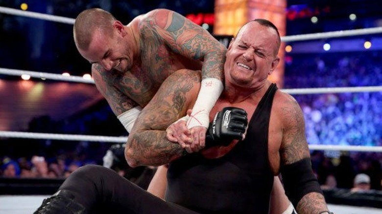 CM Punk grabs The Undertaker