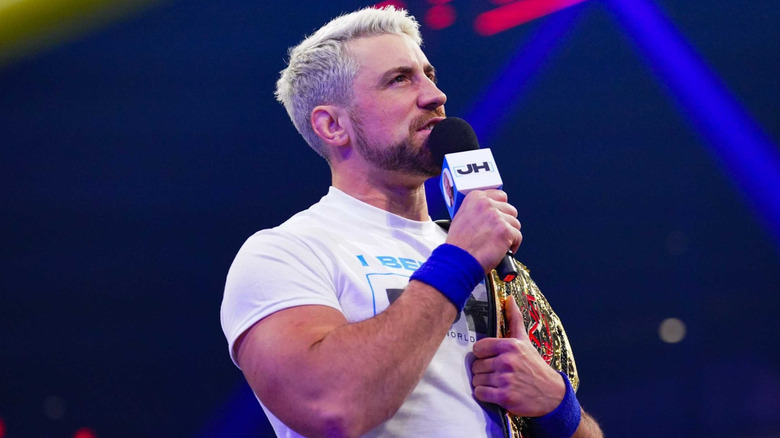 Joe Hendry holding a microphone