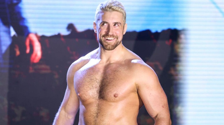 Joe Hendry stands grinning on the stage at "WWE NXT" before he heads down to the ring for a match.