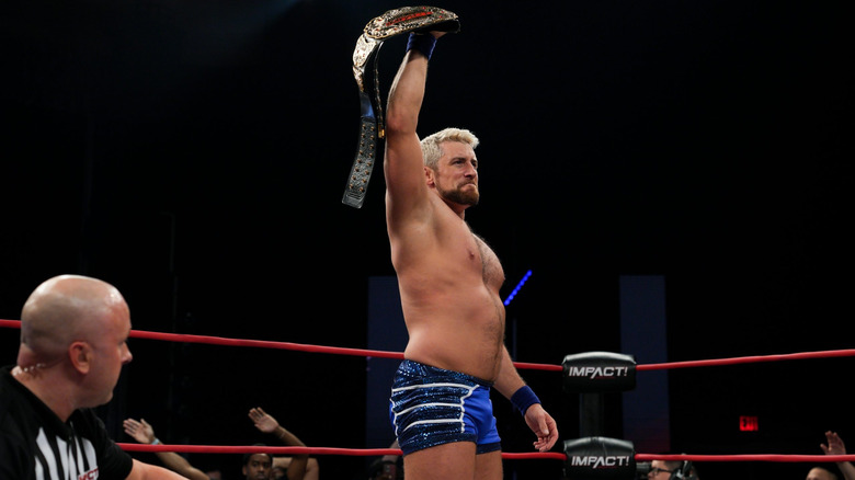 Joe Hendry holding aloft the title