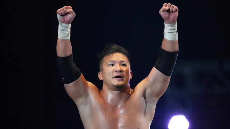 KUSHIDA raising his arms in the air