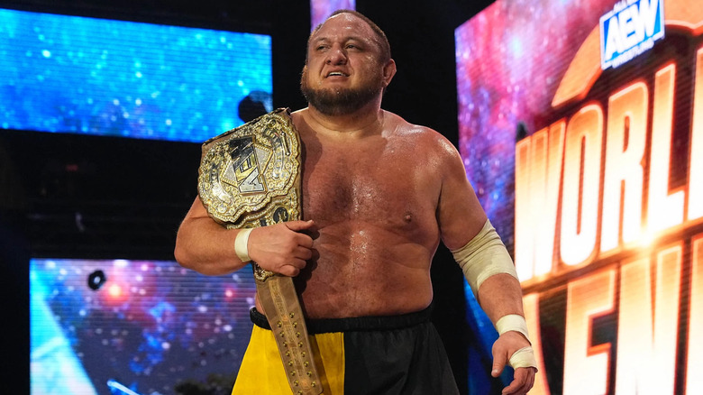 Samoa Joe holding title belt