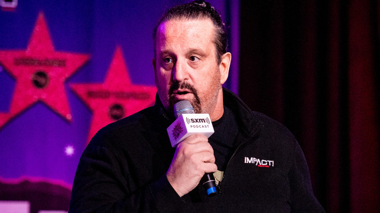 Tommy Dreamer holding a microphone