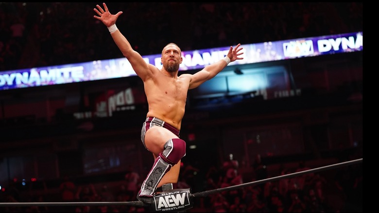 Bryan Danielson stands atop the ropes and poses for the crowd