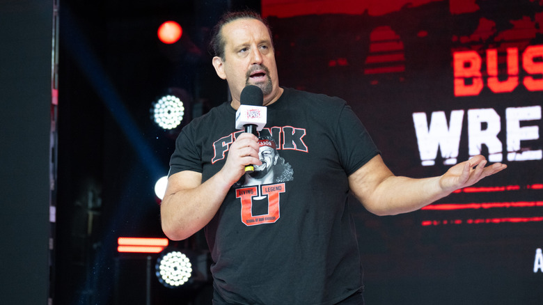 Tommy Dreamer holding a microphone at an event