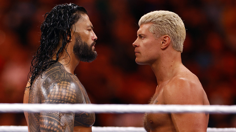 Cody Rhodes and Roman Reigns stare each other down