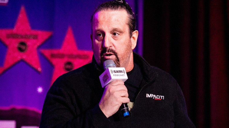 Tommy Dreamer holding a microphone
