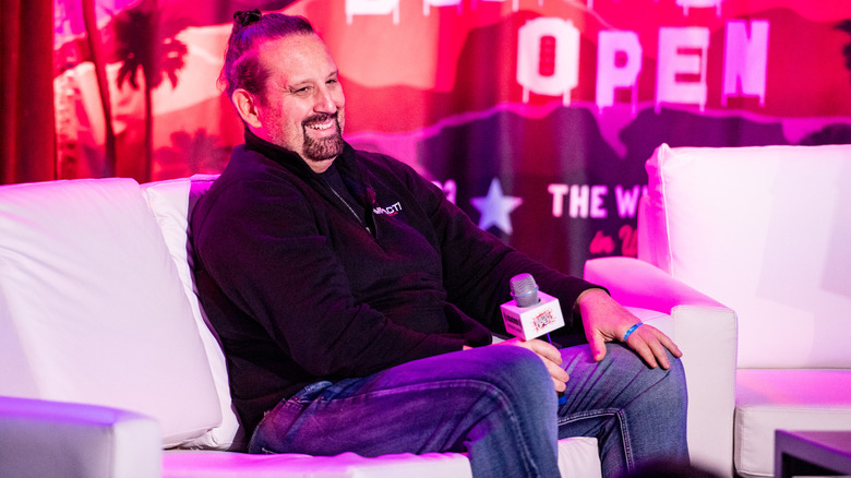 Tommy Dreamer holding a microphone at an event