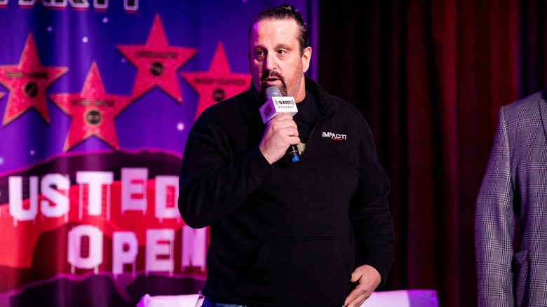 Tommy Dreamer talking into a microphone at an event