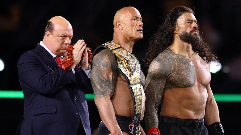 Paul Heyman, Dwayne "The Rock" Johnson and Roman Reigns look on following a fight against Cody Rhodes and Seth "Freakin" Rollins during Night One of WrestleMania 40 at Lincoln Financial Field on April 06, 2024 in Philadelphia, Pennsylvania.