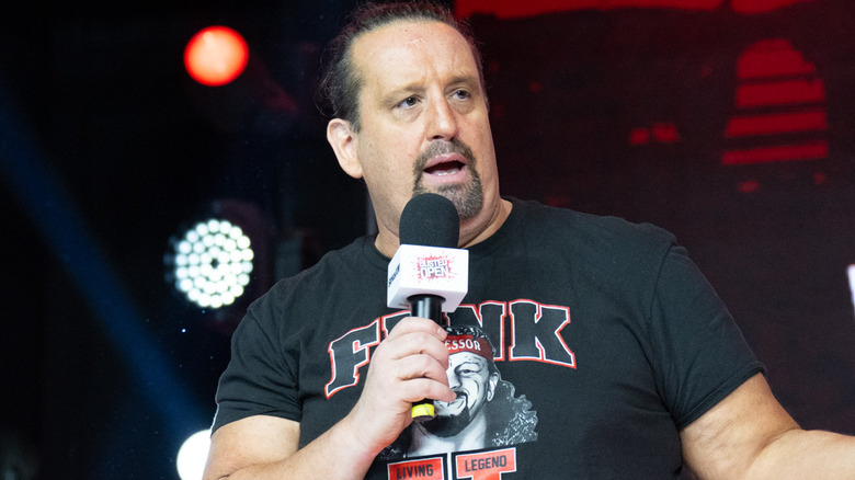 Tommy Dreamer holding a microphone