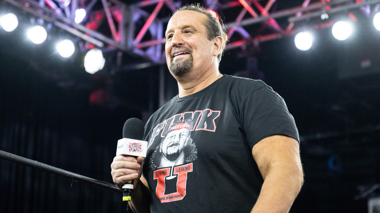 Tommy Dreamer holding a mic and wearing a Terry Funk t-shirt