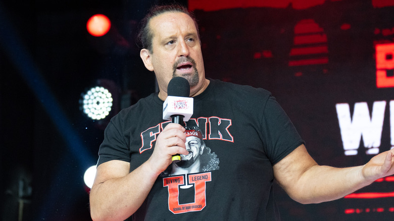 Tommy Dreamer is talking into microphone.