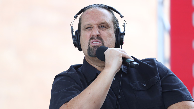 Tommy Dreamer snarls while wearing large headphones