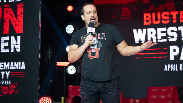 Tommy Dreamer holding a microphone at an event