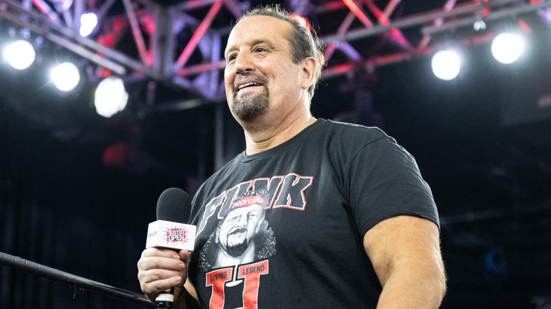 Tommy Dreamer stands in the ring greeting the crowd