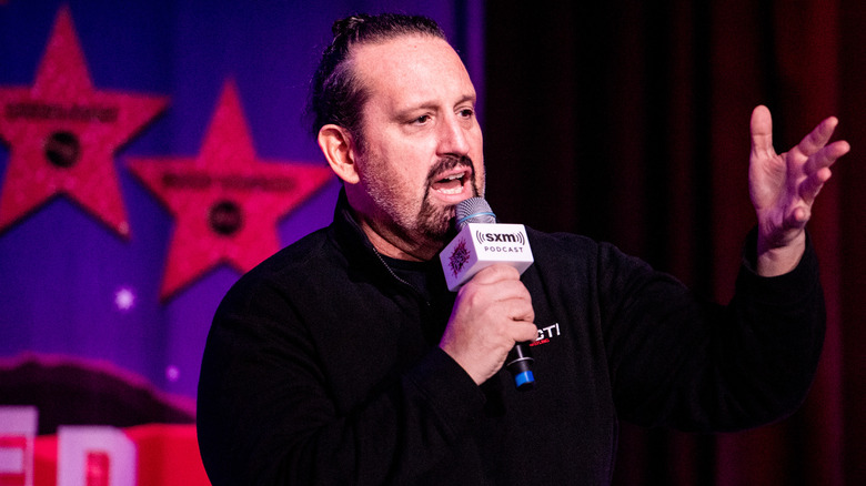 Tommy Dreamer gesturing with mic in hand