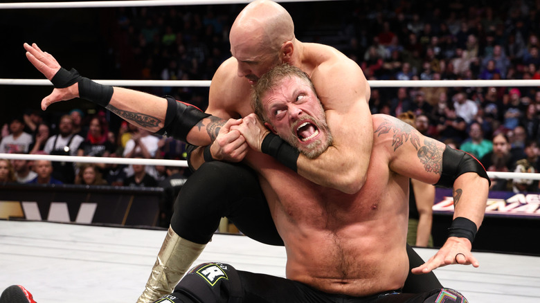 Adam Copeland attempts to get out of a headlock by the Death Rider's Claudio Castagnoli during a match on 