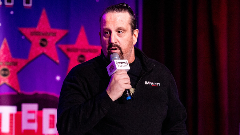 Tommy Dreamer holding a microphone