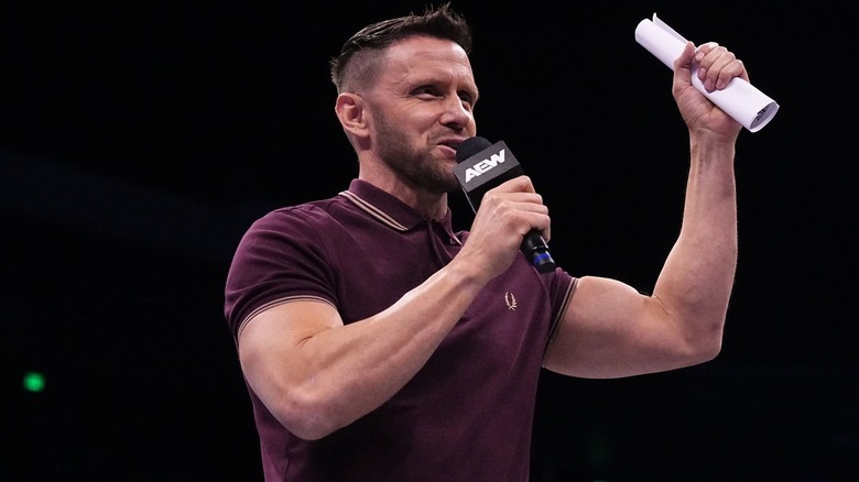 Nigel McGuinness holding a piece of paper