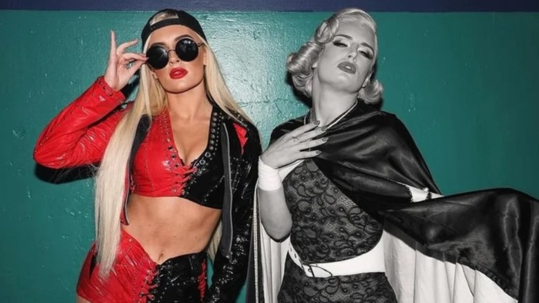 Mariah May poses as the "old" Toni Storm alongside Storm, dressed in her "Timeless" Toni Storm gimmick backstage in AEW.