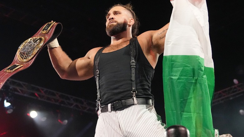 Tony D'Angelo holding an Italian flag and the NXT North American Championship