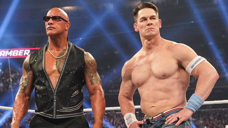 The Rock and John Cena reacting to the crowd boos during Elimination Chamber