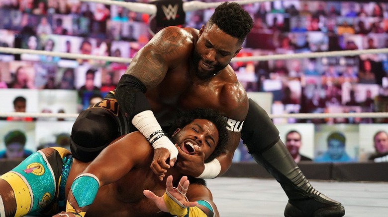 Cedric Alexander putting Xavier Woods into a submission hold