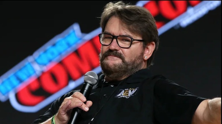 Tony Schiavone, with a microphone in hand, gets ready to interview an AEW star