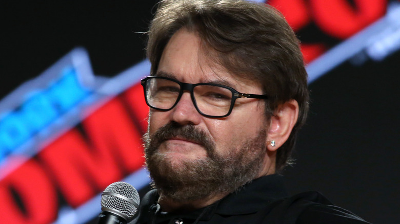 Tony Schiavone looking at camera with a microphone