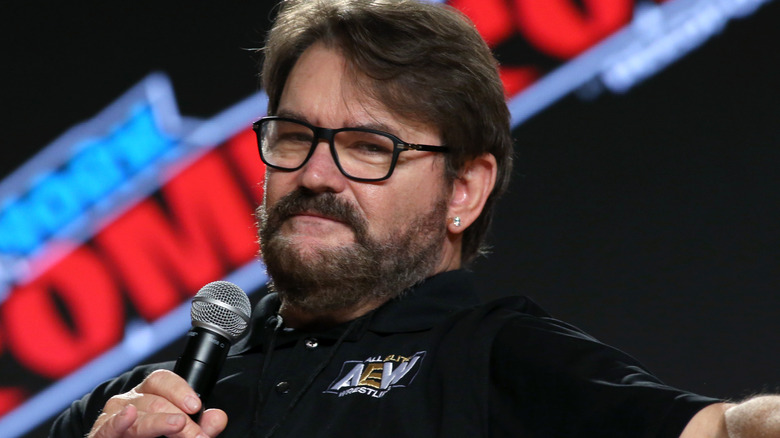 Tony Schiavone holding a microphone at a convention