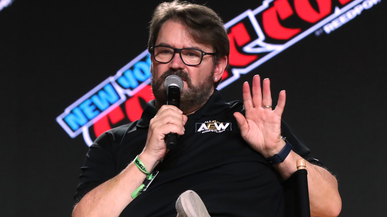 Tony Schiavone likely signaling someone to talk to the hand