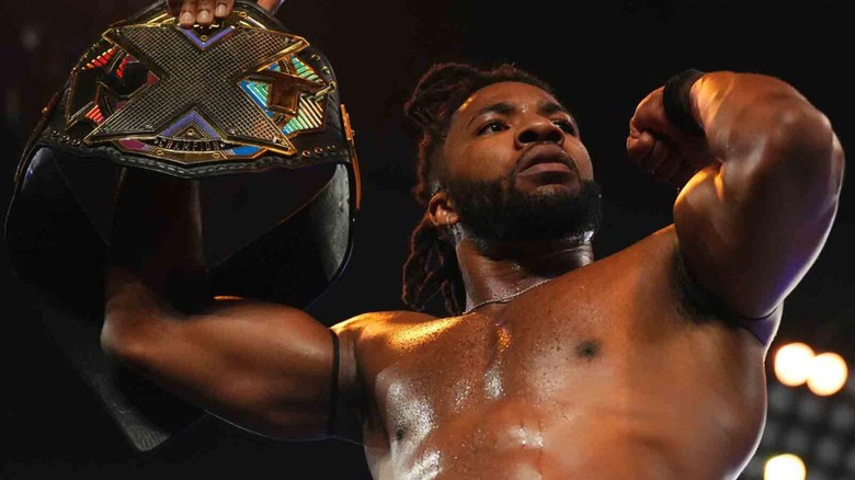 Trick Williams posing with the NXT Championship ahead of his match against Ethan Page