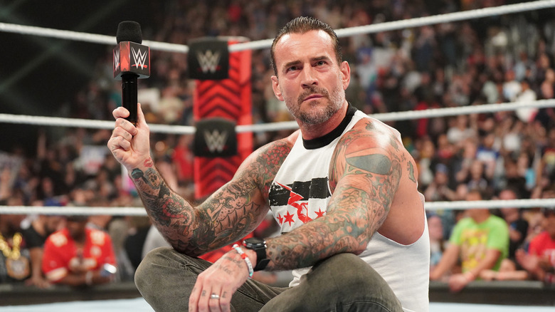 CM Punk sits in the ring