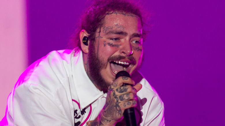 Post Malone singing into microphone