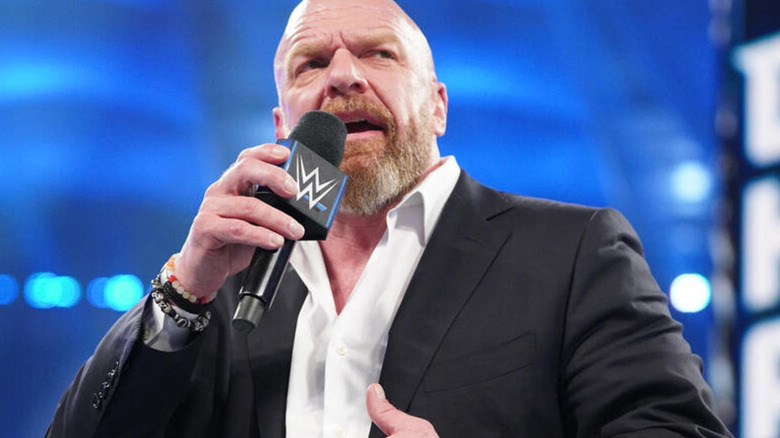 Paul "Triple H" Levesque holds the microphone
